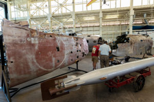 The outer wing and forward fuselage of Pacific Aviation Museum Pearl Harbor&apos;s Nakajima Kate, shown behind a WWII torpedo. Members of Lt Ted Shealy&apos;s Restoration Shop perform preservation work on the delicate airframe. (PRNewsFoto/Pacific Aviation Museum Pearl...)