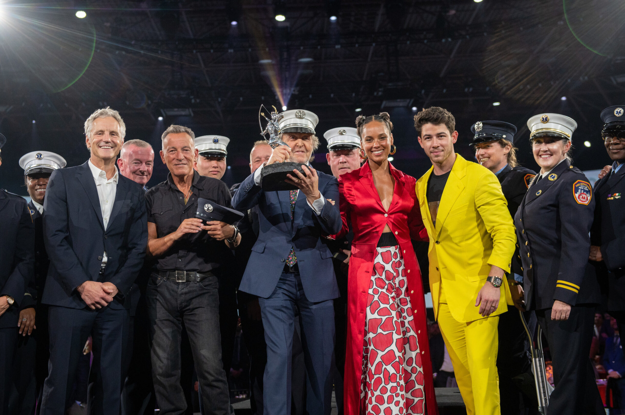 John Sykes, Bruce Springsteen, Alicia Keys, Nick Jonas and a group of a group of New York City firefighters present Paul McCartney with Robin Hood’s prestigious Silver Archer Award for his two-decade long partnership with the organization. Source: Getty Images
