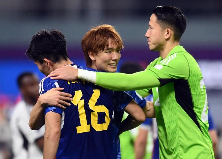 Japan's Kou Itakura celebrates with Takehiro Tomiyasu and Daniel Yabuki after the match REUTERS Annegret Hilse