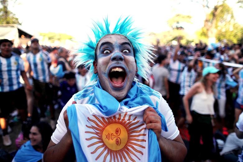 An Argentina fan celebrates after their match against Mexico. REUTERS/Agustin Marcarian